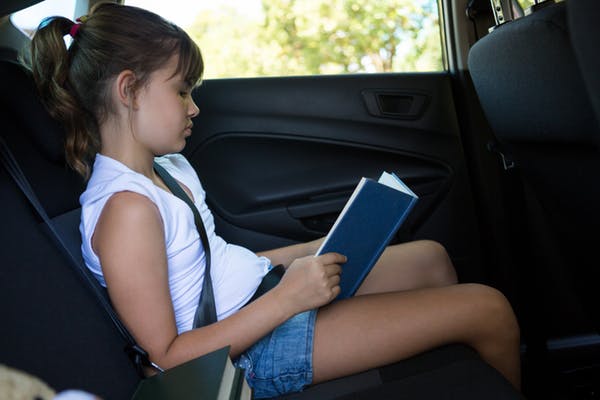 girl reading in car