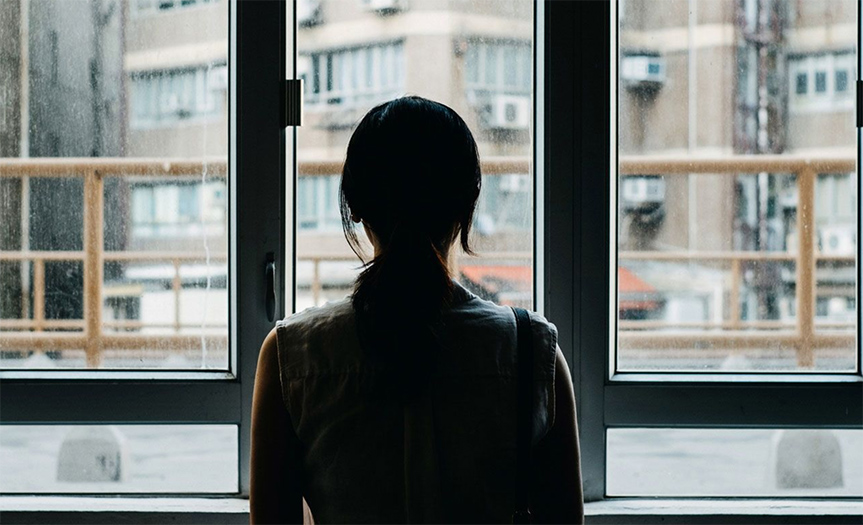 woman looking out window