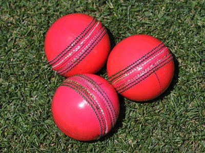 three pink cricket balls