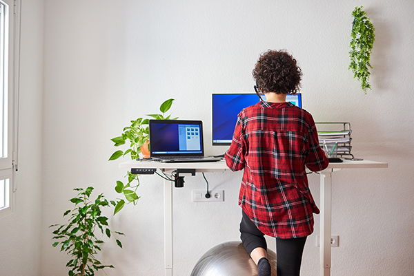 Lady standing at a sit-stand desk