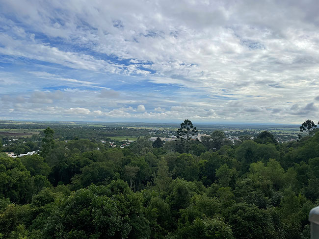 Aerial view of small town from lookout, showing buildings, roads, and urban sprawl.