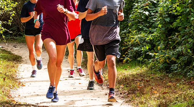 Group of teenagers running on trail