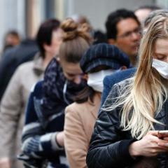 queue of people wearing face masks