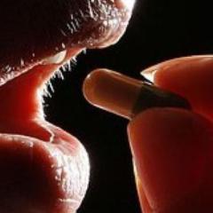 man swallowing pill