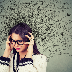 Woman holding head stressed with graphic of black squiggle lines coming from head