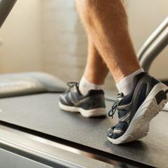 close up of male walking on treadmill