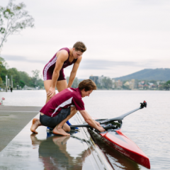 Sports coaching graduate and student preparing to row