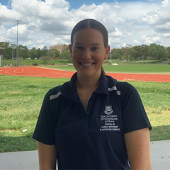 Cecilia Ryan standing outside in front of a sports field