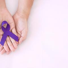 Epilepsy awareness purple ribbon in hands