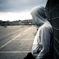 teen leaning against wall