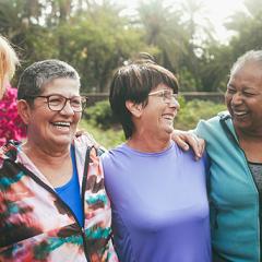  A diverse group of elderly individuals smiling happily in a group photo.