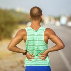 man holding his back in pain