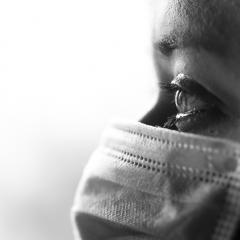 Black and white photo of person wearing mask 