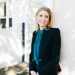 Dr Kate Witteveen leaning against a wall