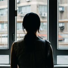 woman looking out window