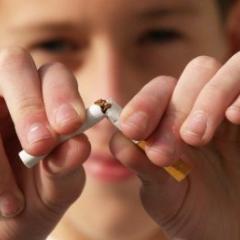 woman snapping cigarette in half