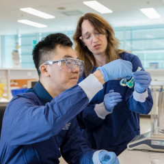 A student and teacher in a pharmaceutical lab