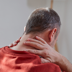 Man holding back of neck 
