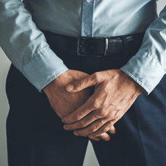 Man holding crotch area