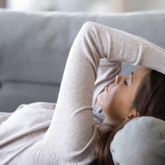 Woman lying on couch 