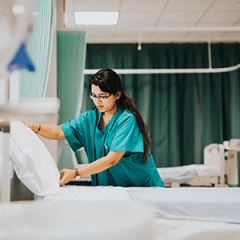 Nurse adjusts a hospital bed