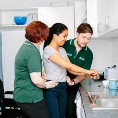 Two occupational therapy students with a patient 
