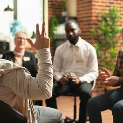 Person raising hand in focus group