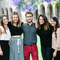 Group of five students posing for a photograph