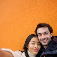young interracial couple taking a selfie