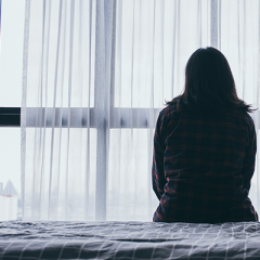 woman sitting on bed
