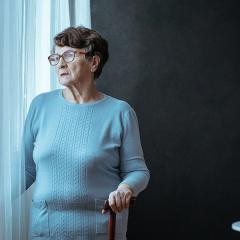 older woman looking out window