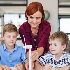 Teacher showing students wind turbine 