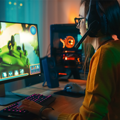 Woman play computer game wearing headset