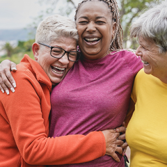 Group of women friends hugging and laughing