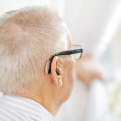 older man with hearing aid