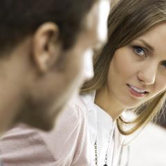 woman looking suspiciously at man