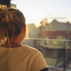 woman looking out of window 