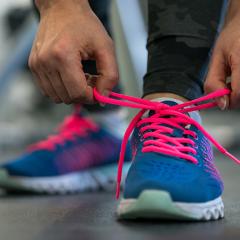 Person tying shoelaces of running shoes