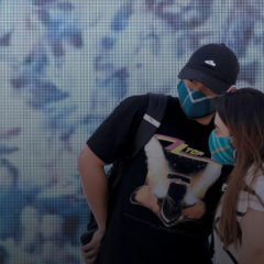 two people wearing masks