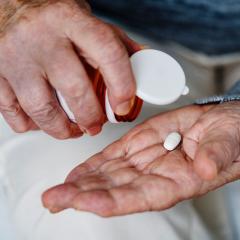 aspirin tablet on a hand
