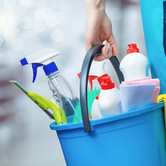 Person holding bucket of cleaning chemicals