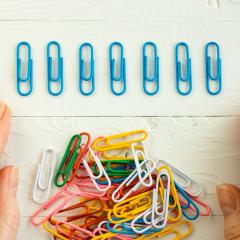 a line of blue paperclips in a row