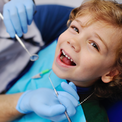 child smiling in dentist chair