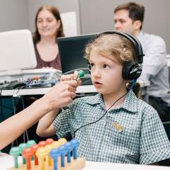 Child patient taking part in a hearing test