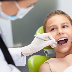 Girl in dentist chair receiving care