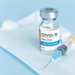 covid vaccine sitting on disposable face mask 