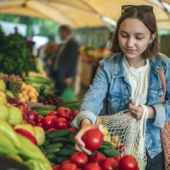 young adult female shopping for fruit and vegetables 