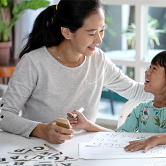 Mother and daughter talking during written activity