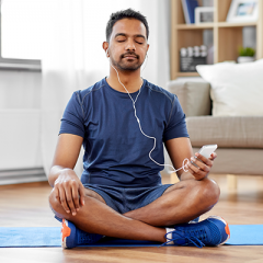 Male meditating with headphones in