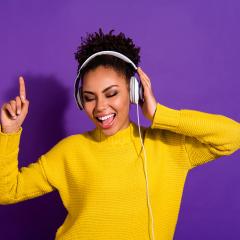 Young woman dancing while wearing headphones